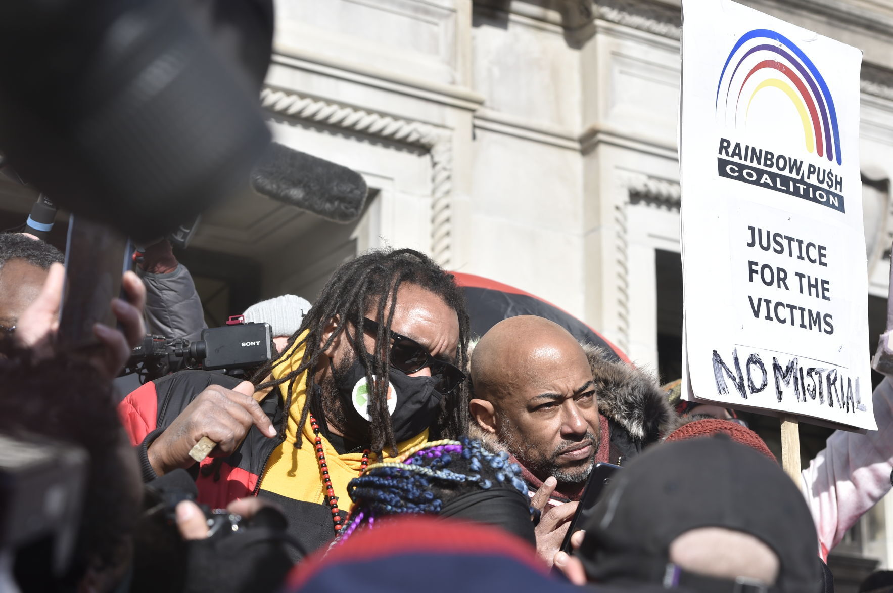 At right, Justin Blake and Bishop Tavis Grant listen to Rittenhouse verdicts